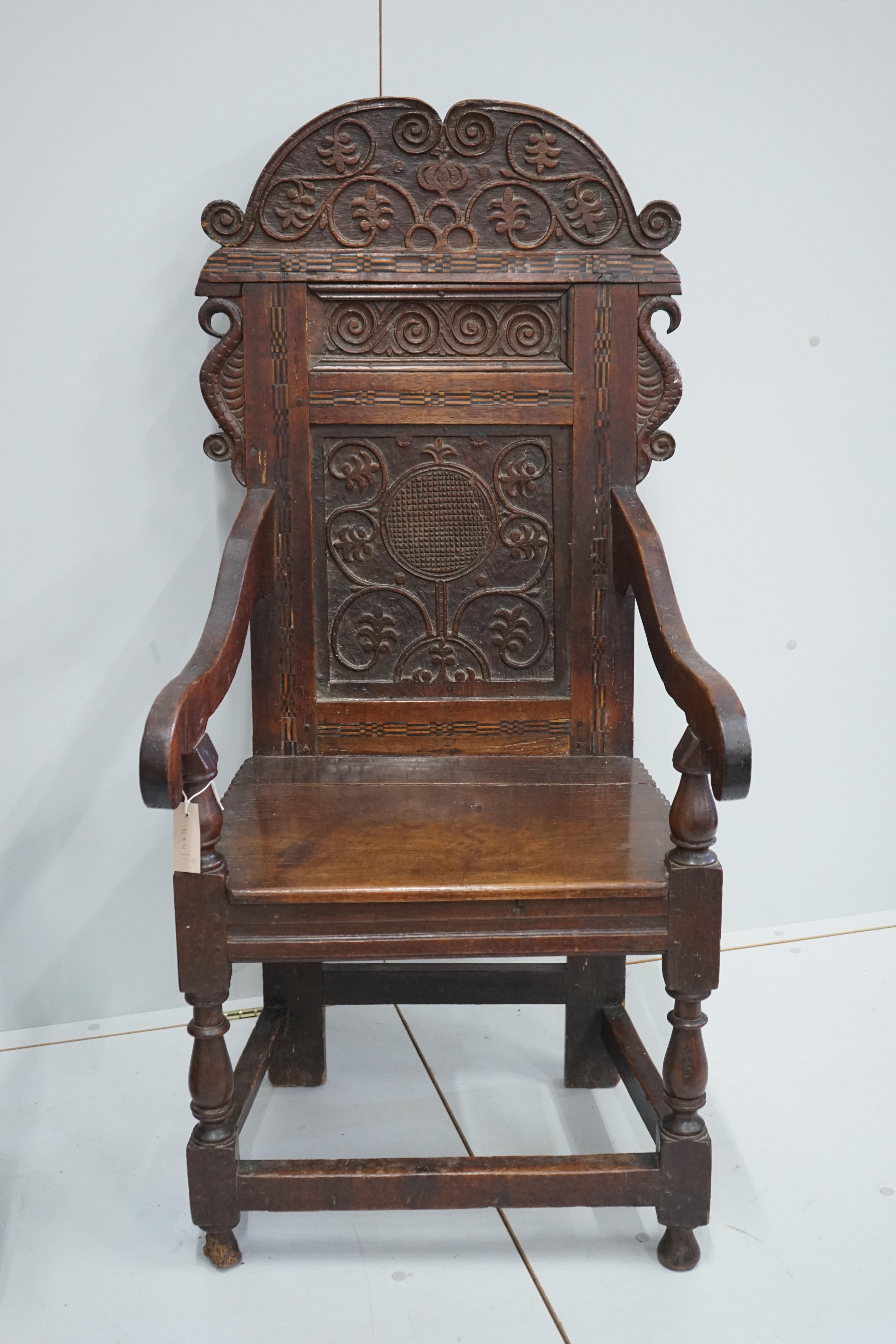 A pair of 17th century style inlaid panelled oak wainscot chairs, width 57cm, depth 40cm, height 121cm